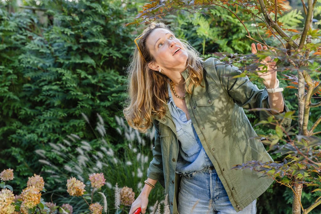 Woman examining tree branches